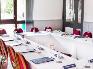 a row of tables in a room with red chairs at Campanile Hotel - Washington in Washington