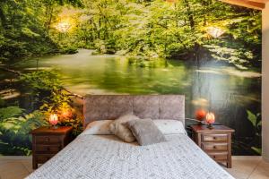 a bedroom with a painting of a river and a bed at Villetta Tiziana in Pisa