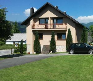 a house with a car parked in front of it at House Pribić in Vrelo Koreničko