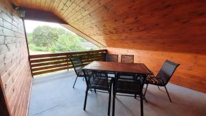 a room with a table and chairs on a balcony at Agro Karasiewo in Karasiewo