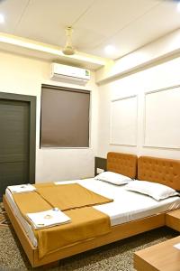 1 dormitorio con 1 cama grande y pantalla de proyección en PRINCE RESIDENCY CLUB HOUSE, en Jamnagar