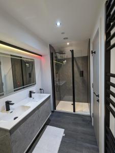 a bathroom with two sinks and a shower at The Wolfe Inn Wolfscastle in Haverfordwest +43 photos