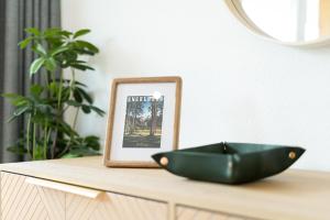 a black bowl sitting on a table next to a picture at Central Serviced Apartment in Engelberg