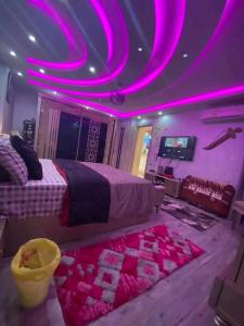 a bedroom with a bed with pink lights on the ceiling at مرسى مطروح in Marsa Matruh