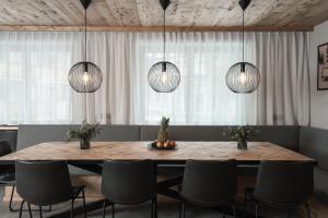 a dining room with a table with chairs and lights at Chalet Pfunds in Pfunds