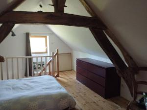 a attic room with a bed and a staircase at Le Bouchat : Maisonnette au calme pour 2 +1 guest 