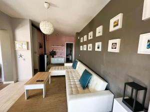 a living room with a white couch and a table at Villa Conchi in Les tres Cales
