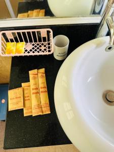 a bathroom counter with a sink and toiletries at Bình Minh Motel Pleiku in Pleiku +18 photos