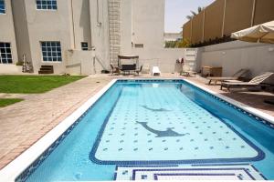 a swimming pool with a dolphin painted on it at Relaxing Private Rooms in Compound Housing near Burj Alarab Villa 124 in Dubai