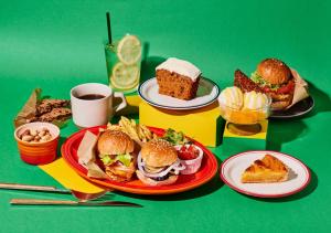 a table with plates of food and cups of coffee at Hotel Graphy Nezu in Tokyo