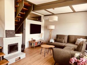 a living room with a couch and a fireplace at leaf in Kirchheim