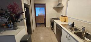 a kitchen with a sink and a stove top oven at Spacious 5-bed house opposite IGA & Golf Course in Kalgoorlie