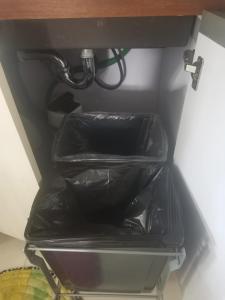 eine Schublade in einem Kühlschrank mit zwei schwarzen Behältern in der Unterkunft 7th Heavens Vacation Home in Banaue