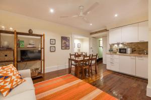 a living room with a kitchen and a dining room at Casa Grande - Minho's Guest in Braga