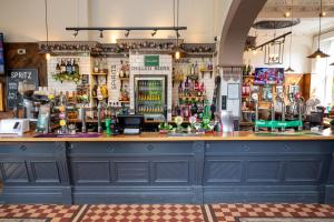 a bar in a pub with a blue counter top at Channings Hotel by Greene King Inns in Bristol