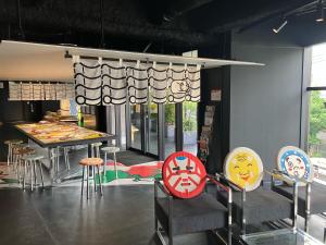 a room with a table and stools in a room at HOTEL TAVINOS Kyoto in Kyoto