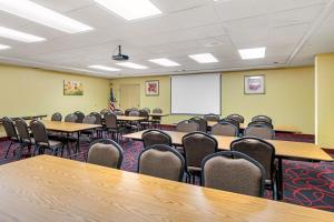 an empty classroom with tables and chairs and a whiteboard at Quality Inn & Suites in Lincoln