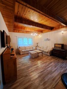 a large living room with couches and a tv at Zelený dom in Modra