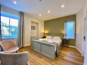 a bedroom with a bed and a desk and a chair at Riverbanc in Llangollen
