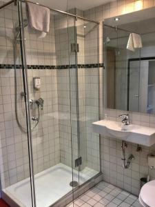 a bathroom with a shower and a sink at Retro - Art - Hotel Lünen in Lünen