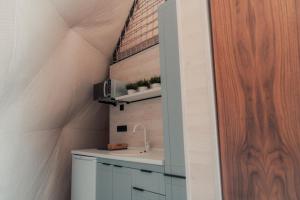 a bathroom with a sink in a room with a roof at O'MIR glamping этно-отель Актау in Kyzylkum