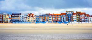 a group of colorful buildings on a beach at Find yourself apartment Dunkerque in Coudekerque-Branche