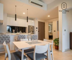 a dining room and kitchen with a table and chairs at AXQUISITE SUITES at KLCC in Kuala Lumpur