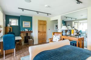 a bedroom with a bed and a desk and a room at Primrose Retreat in Whitby