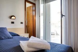 Postel nebo postele na pokoji v ubytování Hotel Villa dei Gerani