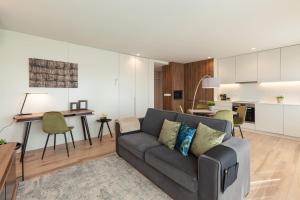 a living room with a couch and a kitchen at ALL4Braga - Minho's Guest in Braga