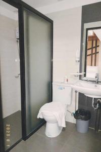 a bathroom with a toilet and a sink at Mbs Hotel (Maramag Business Suites) 