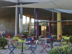 a group of tables and chairs in a courtyard at Leivatho Hotel in Svoronata