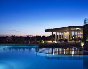 a large swimming pool with a building in the background at Leivatho Hotel in Svoronata