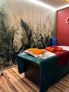 a bedroom with a bed with a painting on the wall at Seven Hotel Bytom - Katowice in Bytom