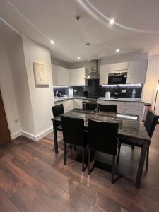 a dining room with a table and chairs in a kitchen at Spacious Sleep 8 Flat 20 mins Central London BP9 in London