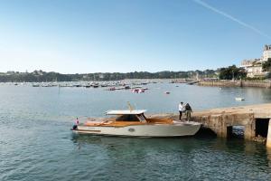 a boat is docked next to a dock at Castelbrac Hotel & Spa in Dinard
