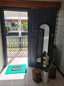 a door leading to a patio with a mirror at The Ideal Bed & Breakfast in Nadi