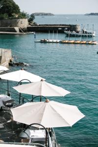 a group of white umbrellas on a boat in the water at Castelbrac Hotel & Spa in Dinard