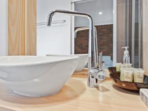 a bathroom with a white bowl sink on a counter at Golfside Getaway 2 by Ready Set Stay in Rosebud