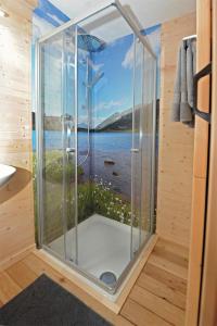 a shower in a bathroom with a view of the water at Ferienhof Holzmeister in Sankt Jakob in Haus