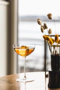 a drink in a martini glass on a table at Castelbrac Hotel & Spa in Dinard
