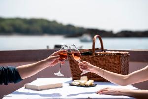 two people holding glasses of wine at a table at Castelbrac Hotel & Spa in Dinard