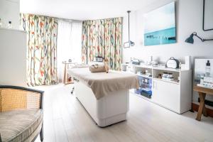 a hospital room with a bed and a table at Castelbrac Hotel & Spa in Dinard