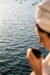 a man standing next to the water looking at the water at Castelbrac Hotel & Spa in Dinard