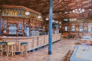 a bar in a pub with wooden walls and chairs at The Black Lion Pub & Boutique Guesthouse in London