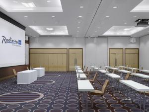 a lecture room with rows of tables and a screen at Radisson Blu Waterfront Hotel, Jersey in Saint Helier Jersey +37 photos
