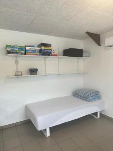 a white bench in a room with shelves at Vestervang bed and breakfast in Nykøbing Mors