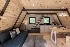 a living room with a blue couch and a table at Chalet Tir Longë in Cesana Torinese