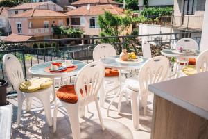 a patio with tables and chairs on a balcony at Guest house Mirah in Ulcinj