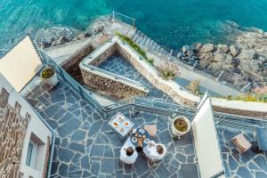 an aerial view of a house with a table and the water at Castelbrac Hotel & Spa in Dinard